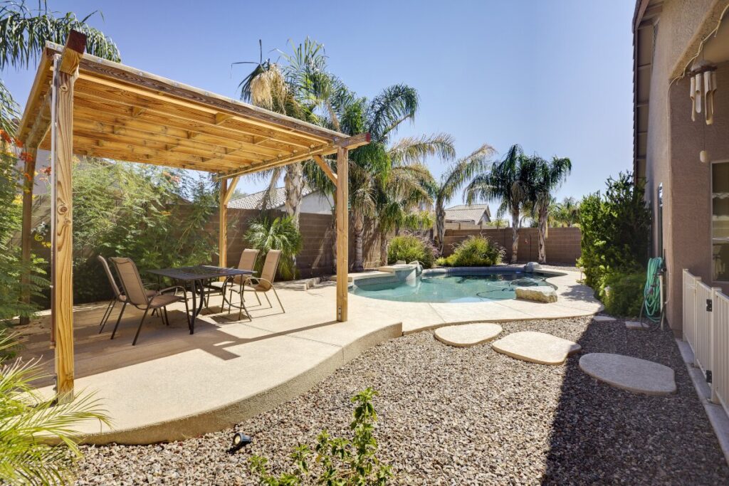 Phoenix backyard with storm debris and shifted gravel after monsoon season