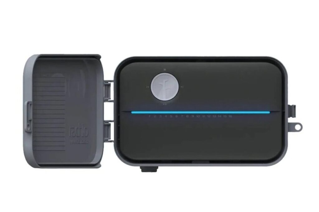 Smart irrigation controller mounted on a garage wall replacing an outdated timer